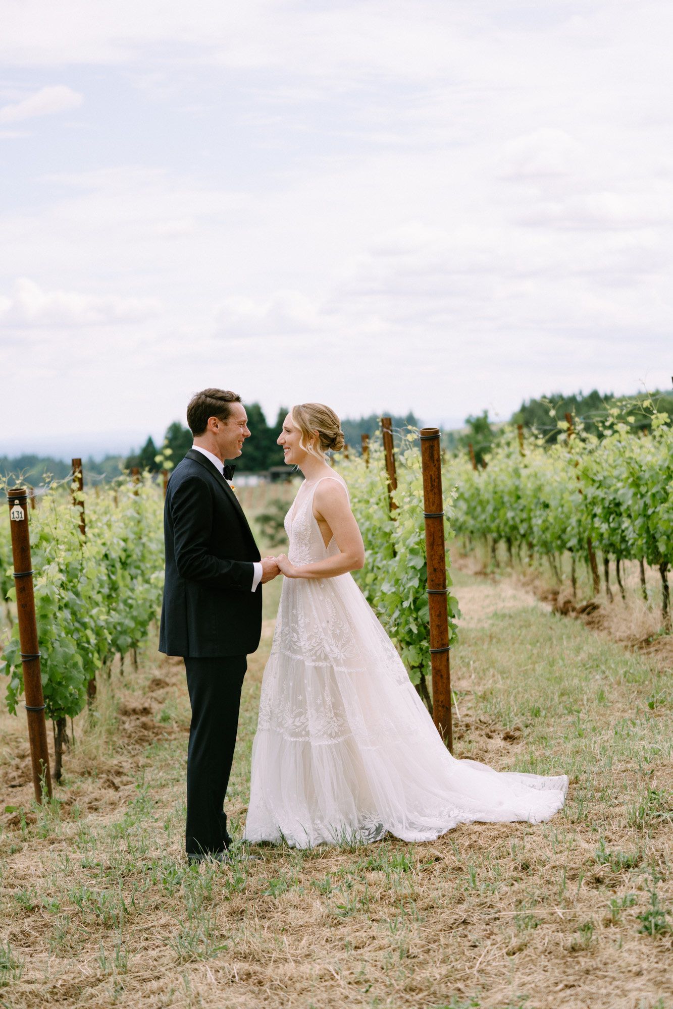 Couple walking through vineyard rows at Black Walnut Inn