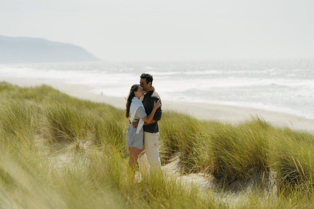 Engagement photos in romantic, rolling grassy hills at the Oregon Coast. 