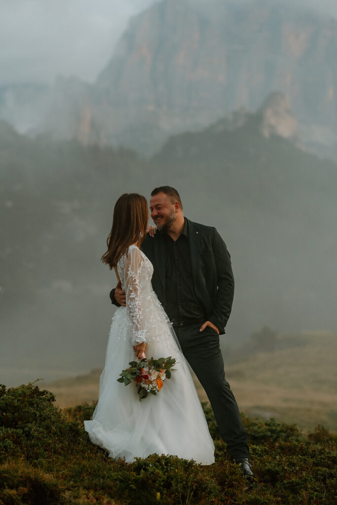 A couple poses for portraits during their elopement in the Italian Dolomites.