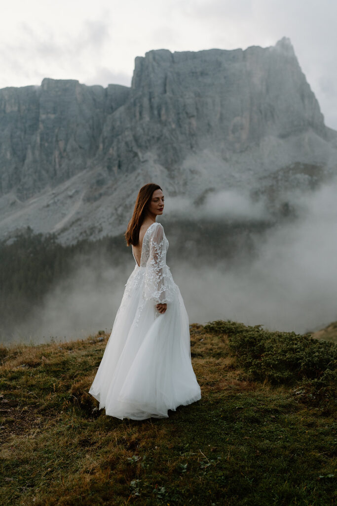 A couple poses for portraits during their elopement in the Italian Dolomites.