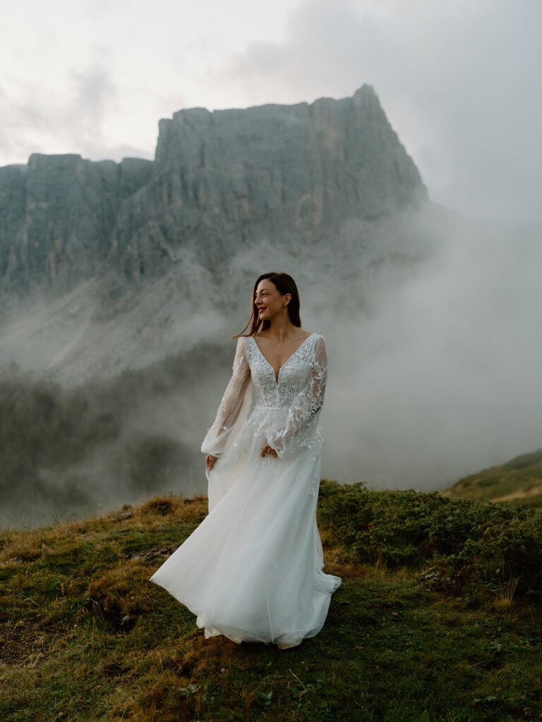 A couple poses for portraits during their elopement in the Italian Dolomites.
