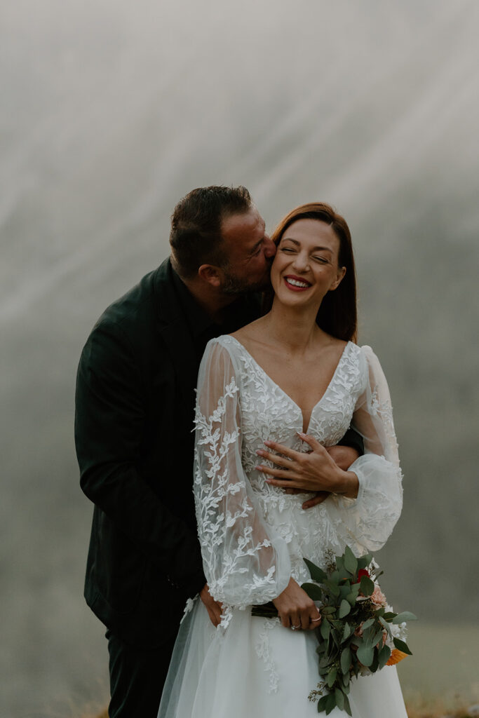 A couple poses for portraits during their elopement in the Italian Dolomites.