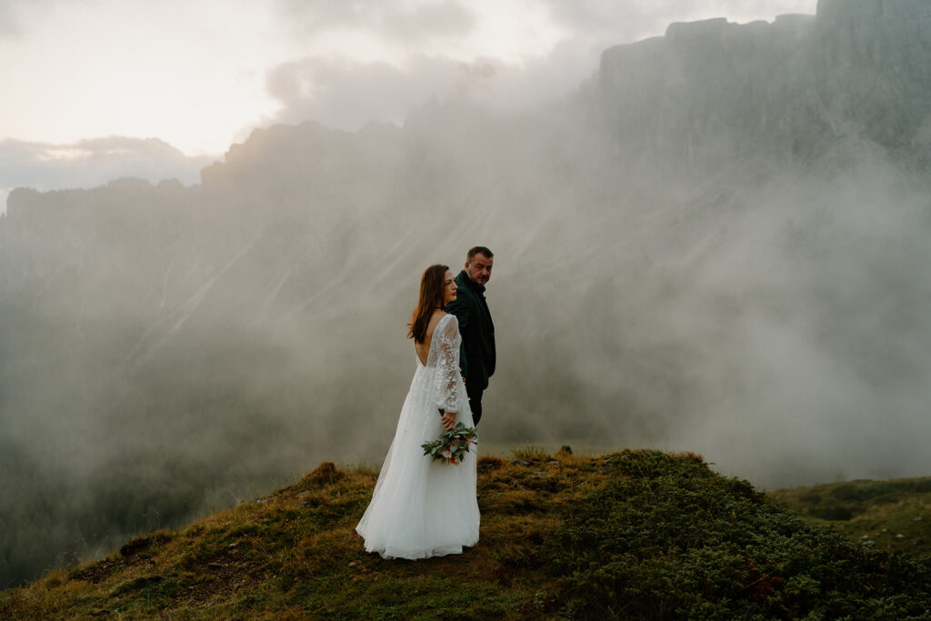 A couple poses for portraits during their elopement in the Italian Dolomites.