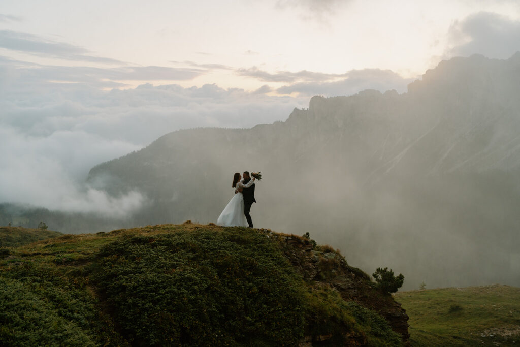 A couple poses for portraits during their elopement in the Italian Dolomites.