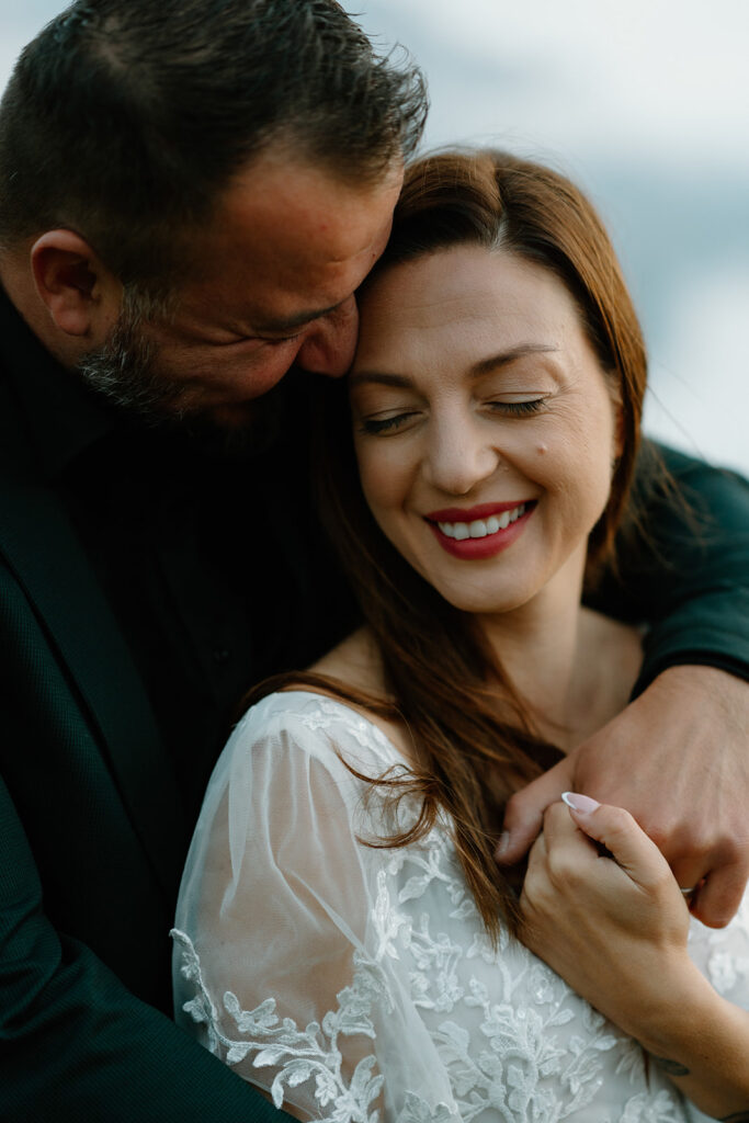 A couple poses for portraits during their elopement in the Italian Dolomites.
