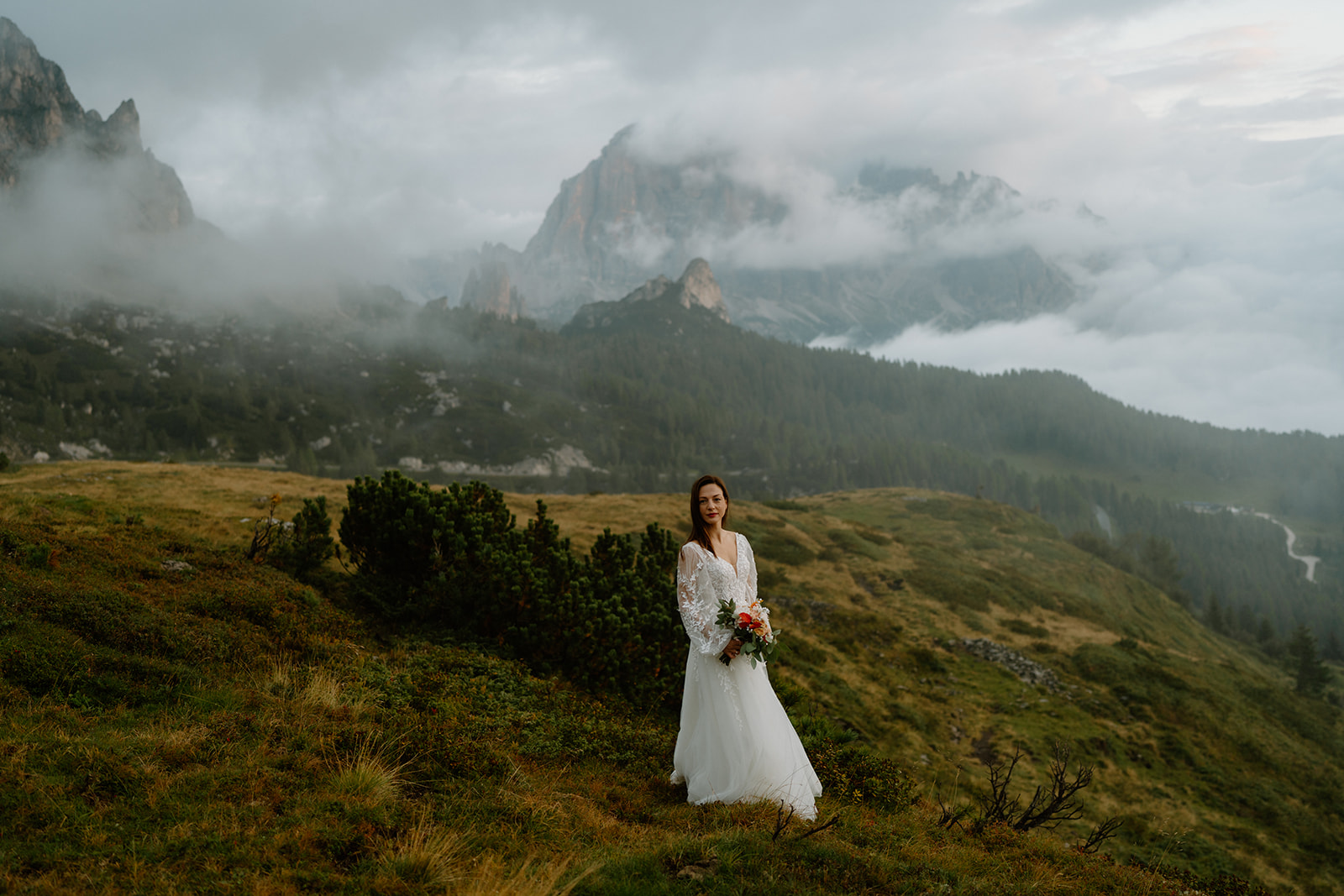 A bride poses for portraits in the Italian Dolomites during her elopement.