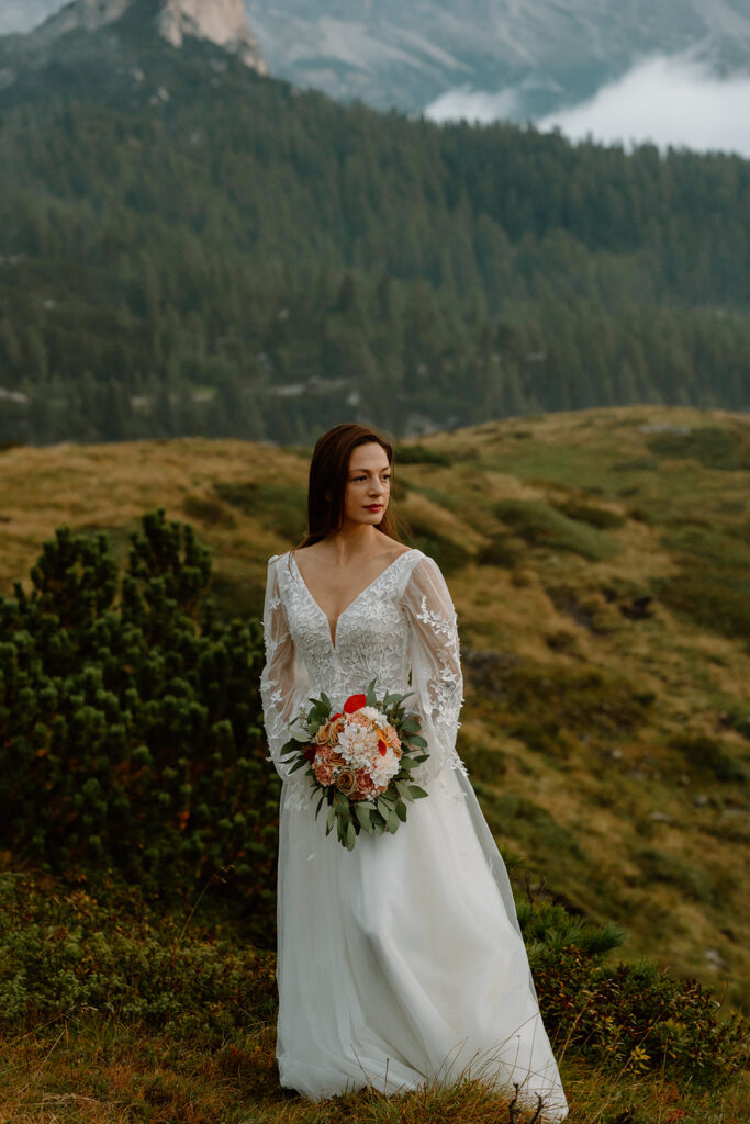 A bride poses for portraits in the Italian Dolomites during her elopement.