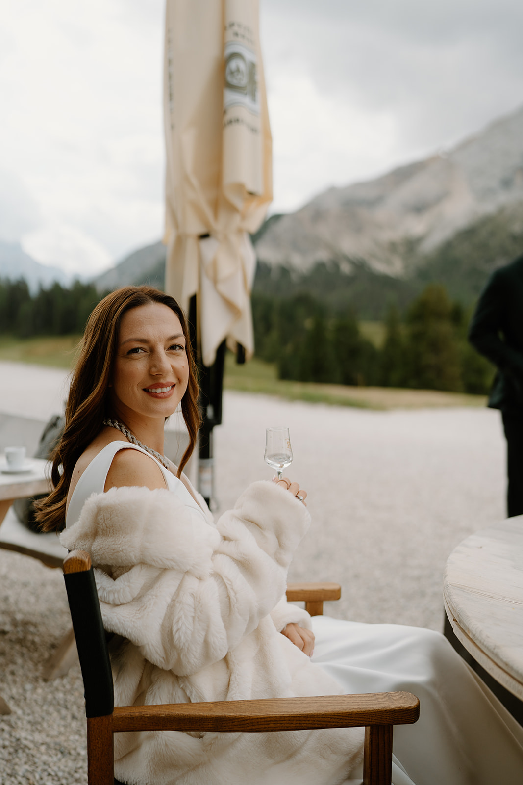 A couple poses in an alpine meadow for their Dolomites elopement photos.
