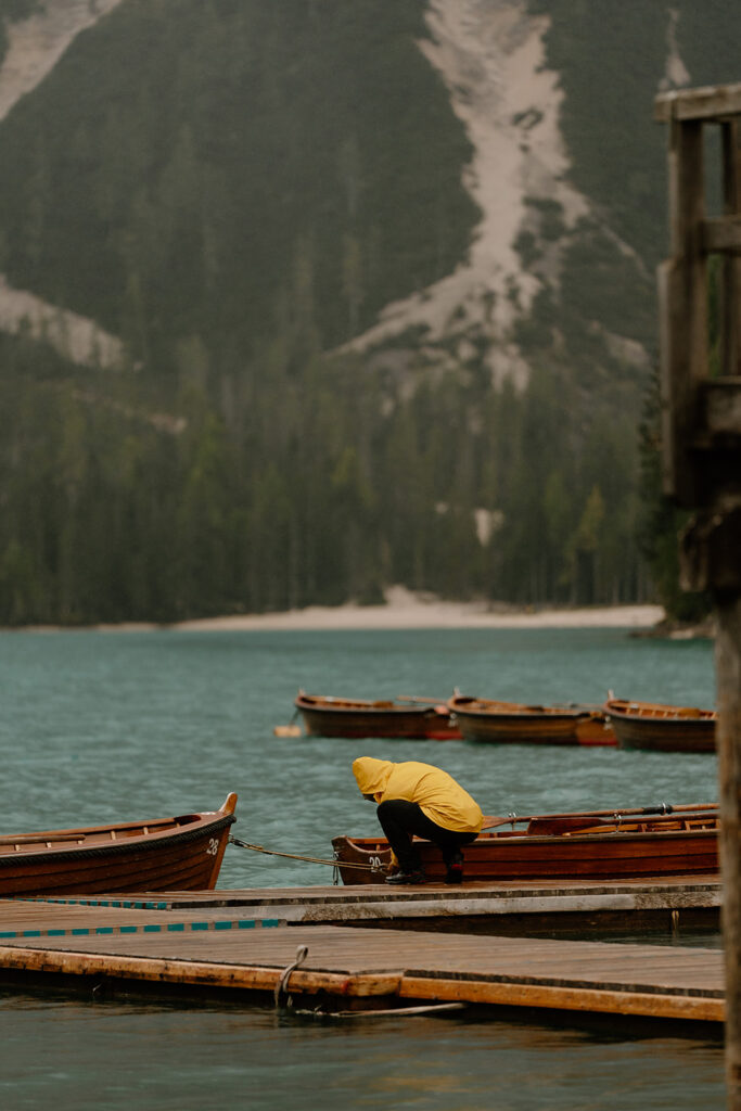 A couple poses for photos during their elopement at Lago di Braies in the Italian Dolomites.