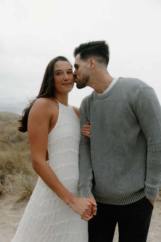A couple poses for their Oregon Coast engagement photo session.