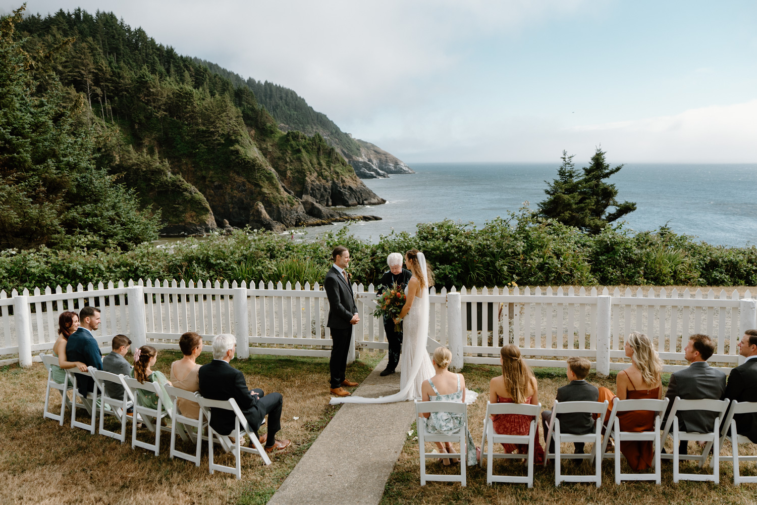 A couple exchanges vows at their Heceta Head lighthouse wedding.