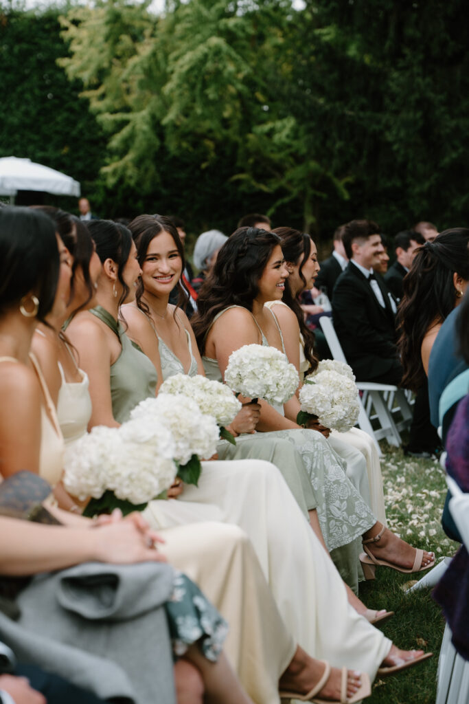 Bridesmaids look on during a wedding ceremony during a Briarwood Estate wedding.