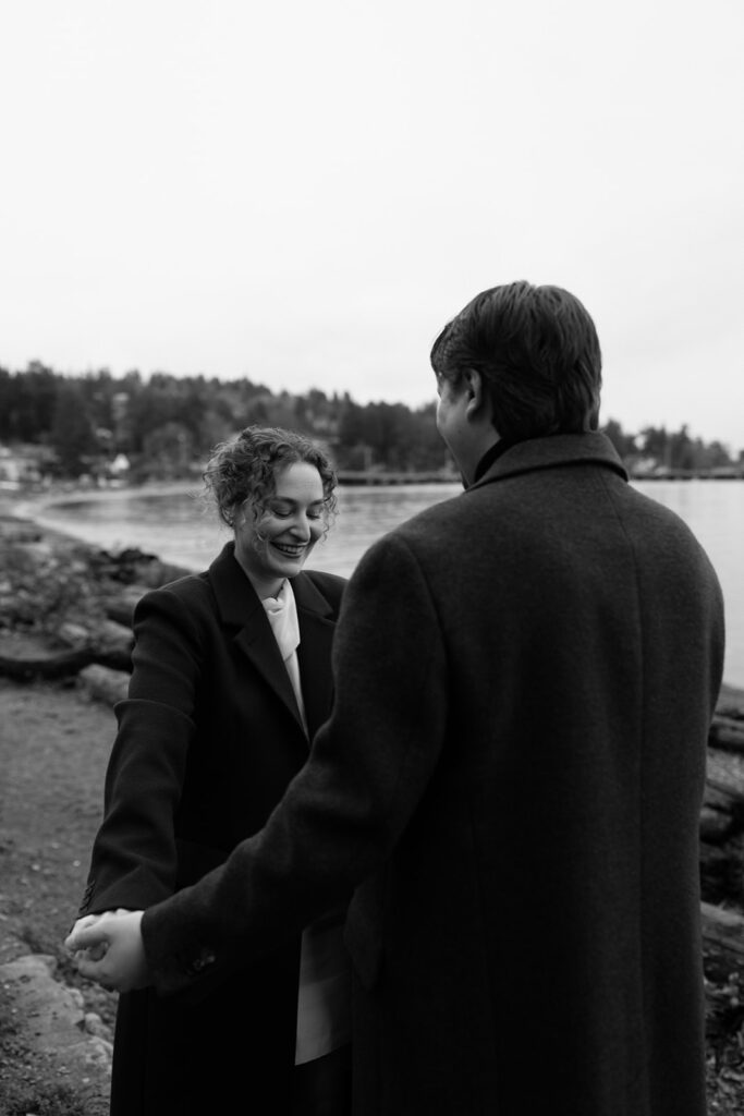 Black and white photo of a couple walking in a park for their Seattle engagement photos