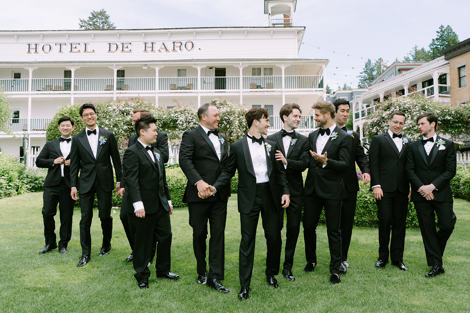 Groomsmen portraits in front of Hotel de Haro at Roche Harbor Resort — one of the most iconic backdrops for San Juan Island wedding photography.