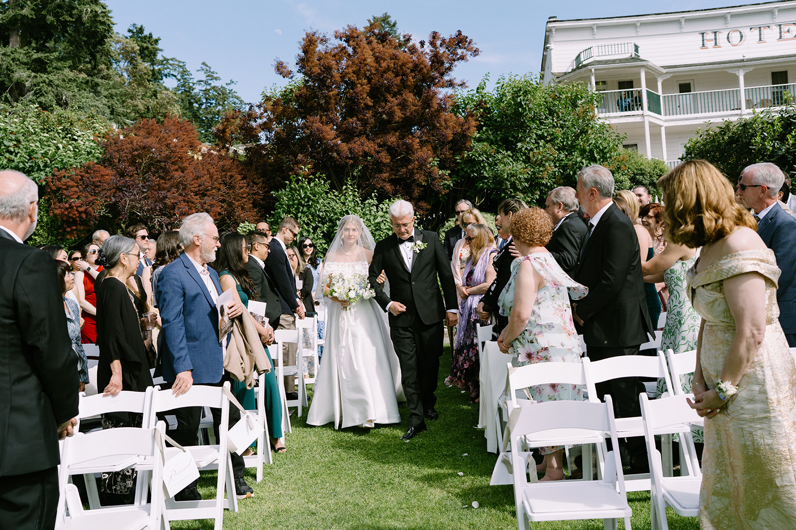 Walking down the aisle at the Roche Harbor Resort garden ceremony, San Juan Island, Washington.
