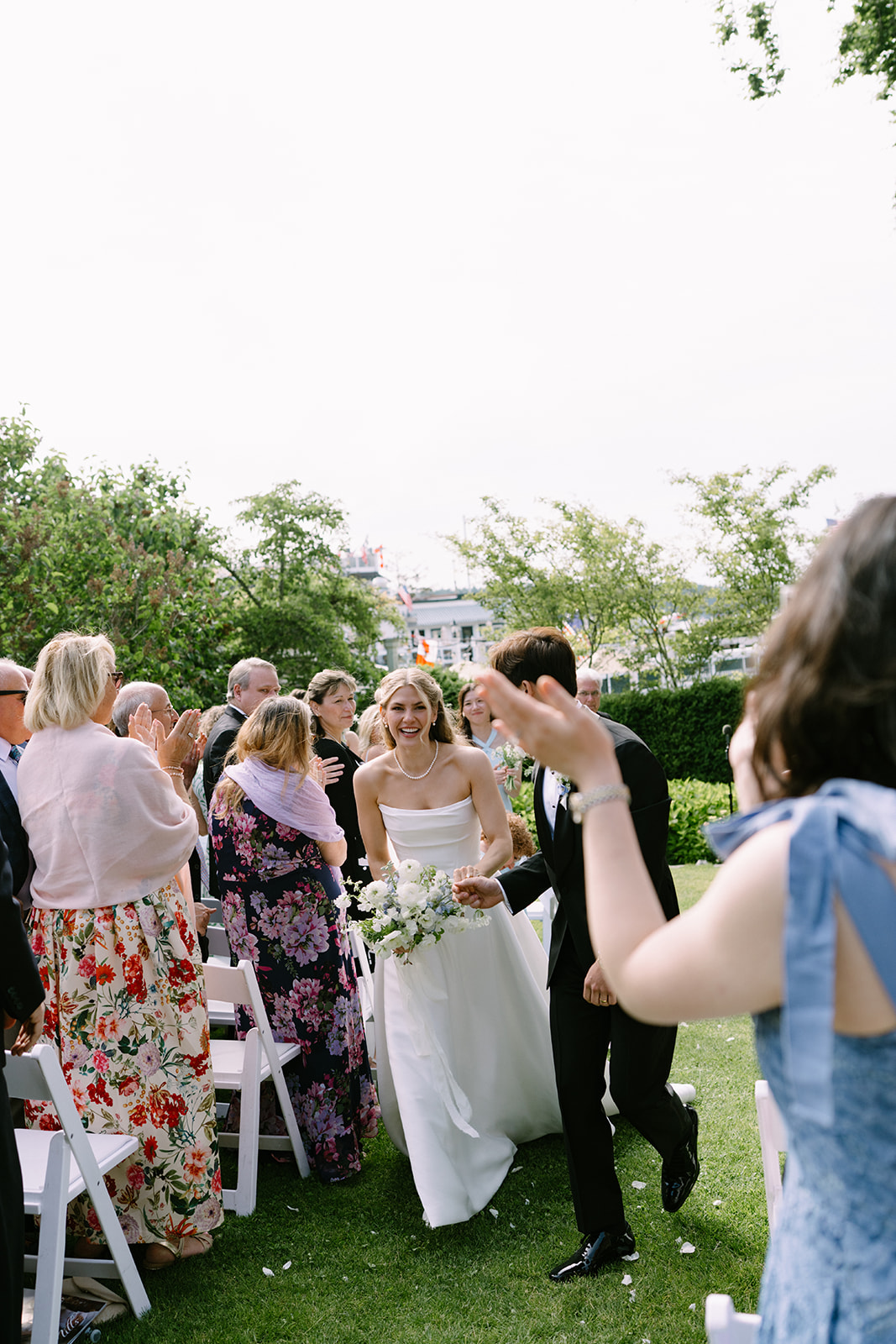 Walking back up the aisle as a married couple at their Roche Harbor Resort wedding — pure joy, San Juan Island, Washington.