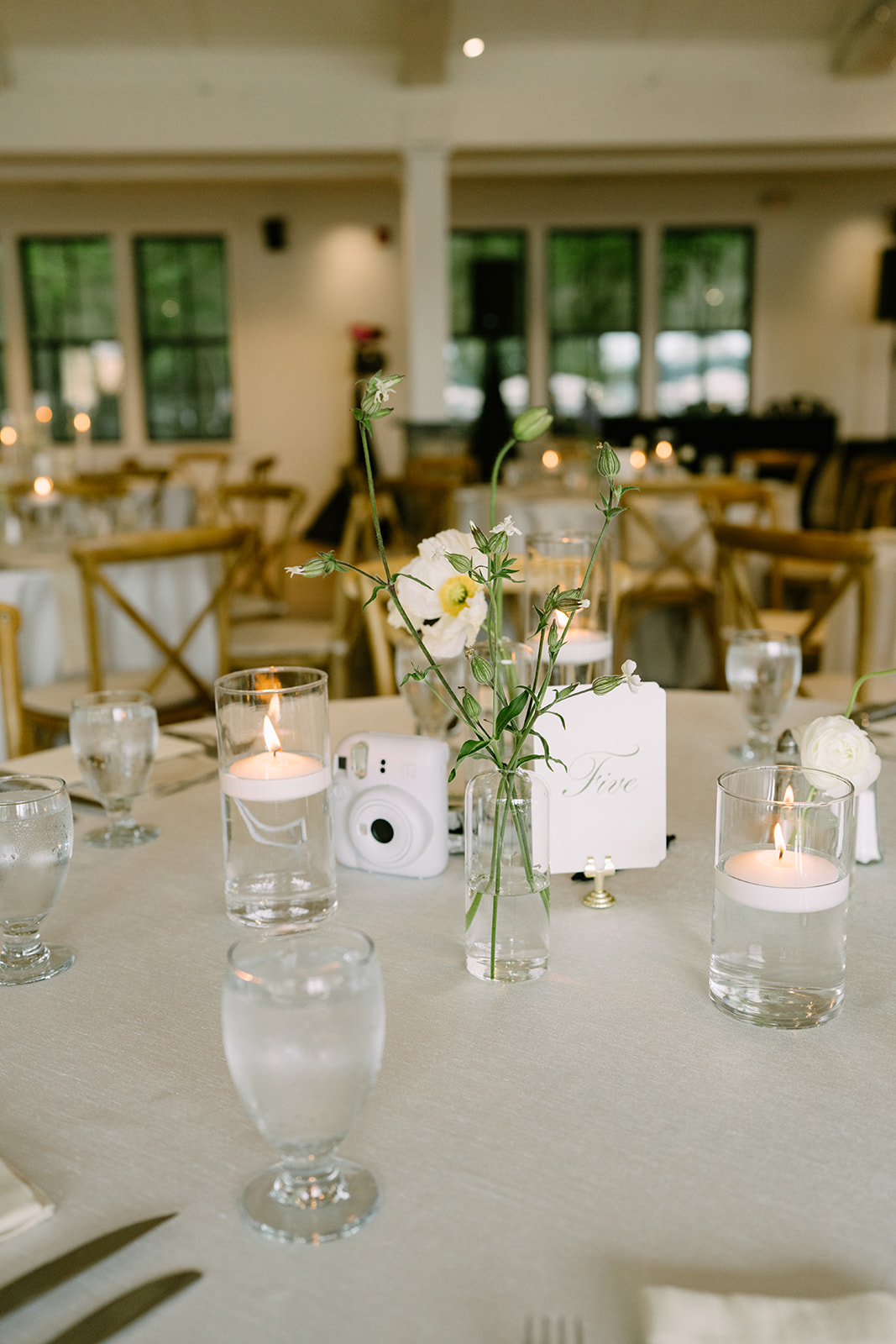 Reception details at Roche Harbor Resort — candlelit tables, florals by Tangled Roots Floral, and views of the San Juan Island waterfront.
