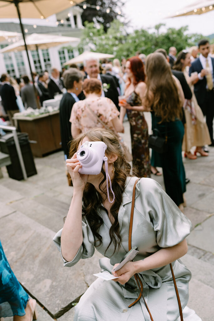 A guest captures the moment on film at this Roche Harbor Resort wedding. San Juan Island, Washington.