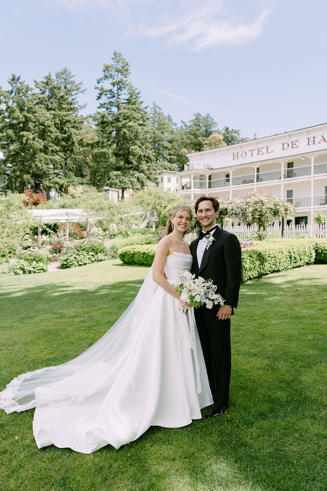 Amanda and Zach's first look portraits in front of the iconic Hotel de Haro at Roche Harbor Resort, San Juan Island, Washington. Photography by Voyage + Vine.