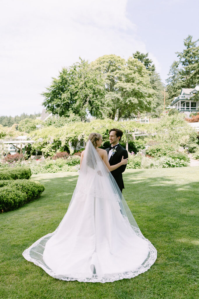 Bridal bouquet by Tangled Roots Floral and cathedral lace veil at this Roche Harbor Resort wedding on San Juan Island.
