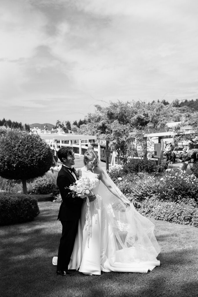 Black and white wedding portraits at Roche Harbor Resort with the marina and PNW treeline in the background.