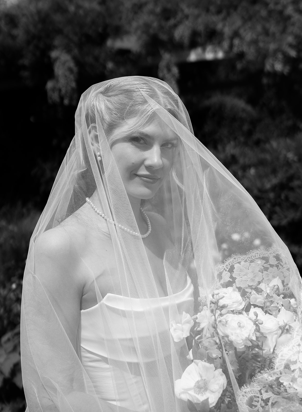 Portrait of Amanda under her cathedral veil in the gardens at Roche Harbor Resort, San Juan Island.