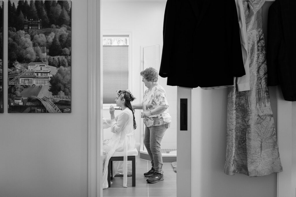 Getting ready separately in cabins at the resort, with the marina just outside the window. San Juan Island wedding photography by Voyage + Vine.