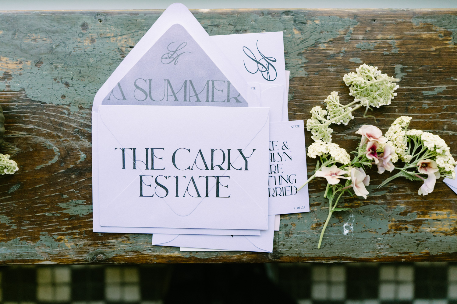 Purple envelopes with "The Carly Estate" written on them for a wedding day.