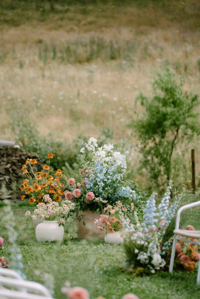 Bright floral arrangements for a wedding ceremony at Maysara Winery
