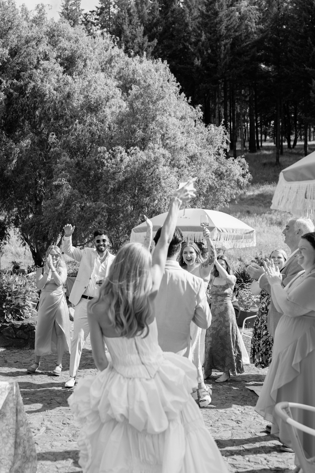 A black and white photo of a couple entering their wedding cocktail hour at Maysara Winery