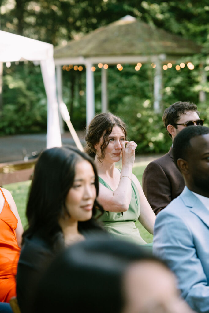 Guests beneath a white garden canopy during the ceremony at Anker Place