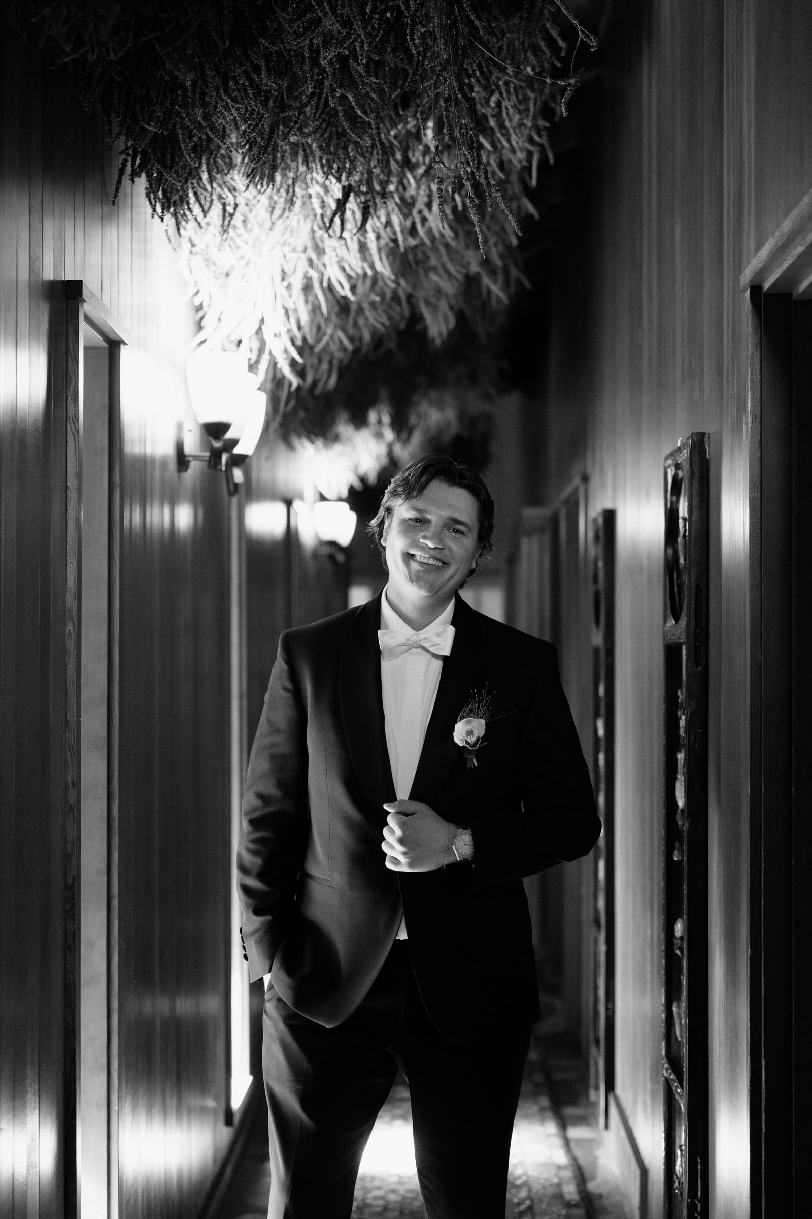 Partner in a dark suit reading a note before the first look inside Anker Place