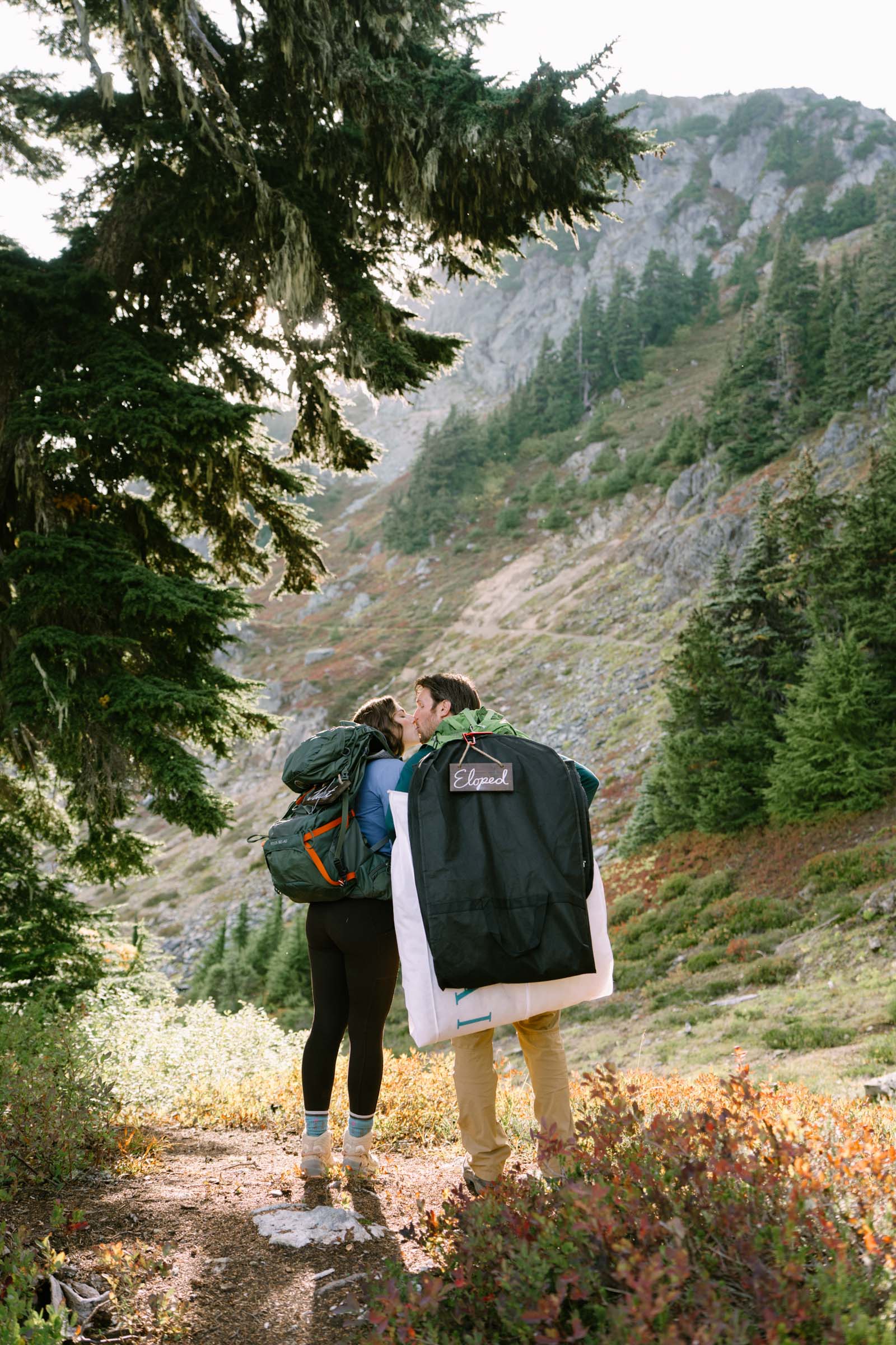 Hiker carrying a loaded pack up the trail toward Winchester Mountain
